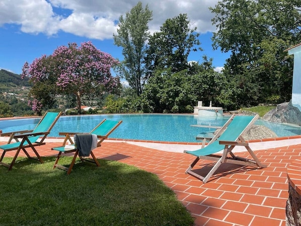 A swimming pool with lounge chairs and a fountain. - Family house with pool at Quinta da Agrela (Portugal) (Vade (São Pedro))