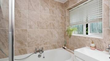 Combined shower/bathtub, deep-soaking bathtub, hair dryer, towels