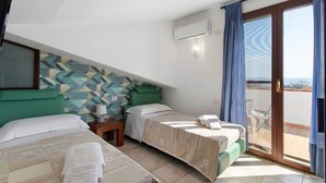 A bedroom with two beds, a patterned wall, an air conditioning unit, and a view through a glass door.
