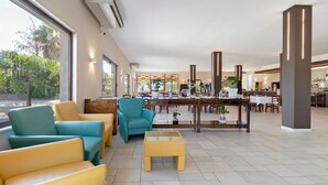 A spacious lobby with seating areas, a reception desk, and a dining area. - Villa Ristòries Room 6 with Terrace, Wi-Fi and Air Conditioning (Matera)