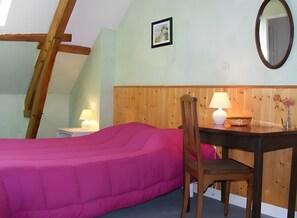 A room with a bed, a desk with a chair, a lamp, a vase with flowers, and a wooden headboard. - Bed and Breakfast 'Chambre Les Fauvettes' with Shared Terrace, Shared Garden and Wi-Fi (Courcemont)