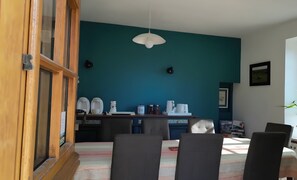 A dining area with a table, chairs, and a ceiling light. - Bed and Breakfast 'Chambre Les Fauvettes' with Shared Terrace, Shared Garden and Wi-Fi (Courcemont)