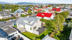 A residential area with houses, a street, and a distant cityscape. - Modern and family friendly house in Reykjavik (Reykjavík)