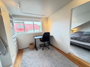 A bedroom with a bed, a desk, and a window. - Modern and family friendly house in Reykjavik (Reykjavík)