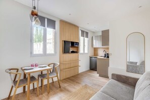 A modern kitchen with wooden cabinets, a built-in microwave, and a dishwasher. - Modern Apartment 1br/4p - Boulogne-billancourt (Boulogne-Billancourt)