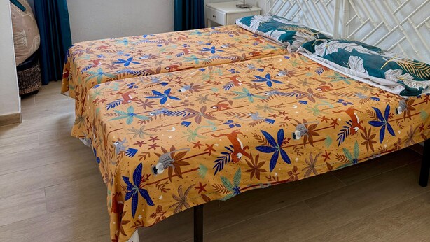 A bedroom with a bed, curtains, a ceiling fan, a window, and a view of the outside. - Terrace with Sea Views at Castillo Bil Bil, Benalmádena (Benalmádena)