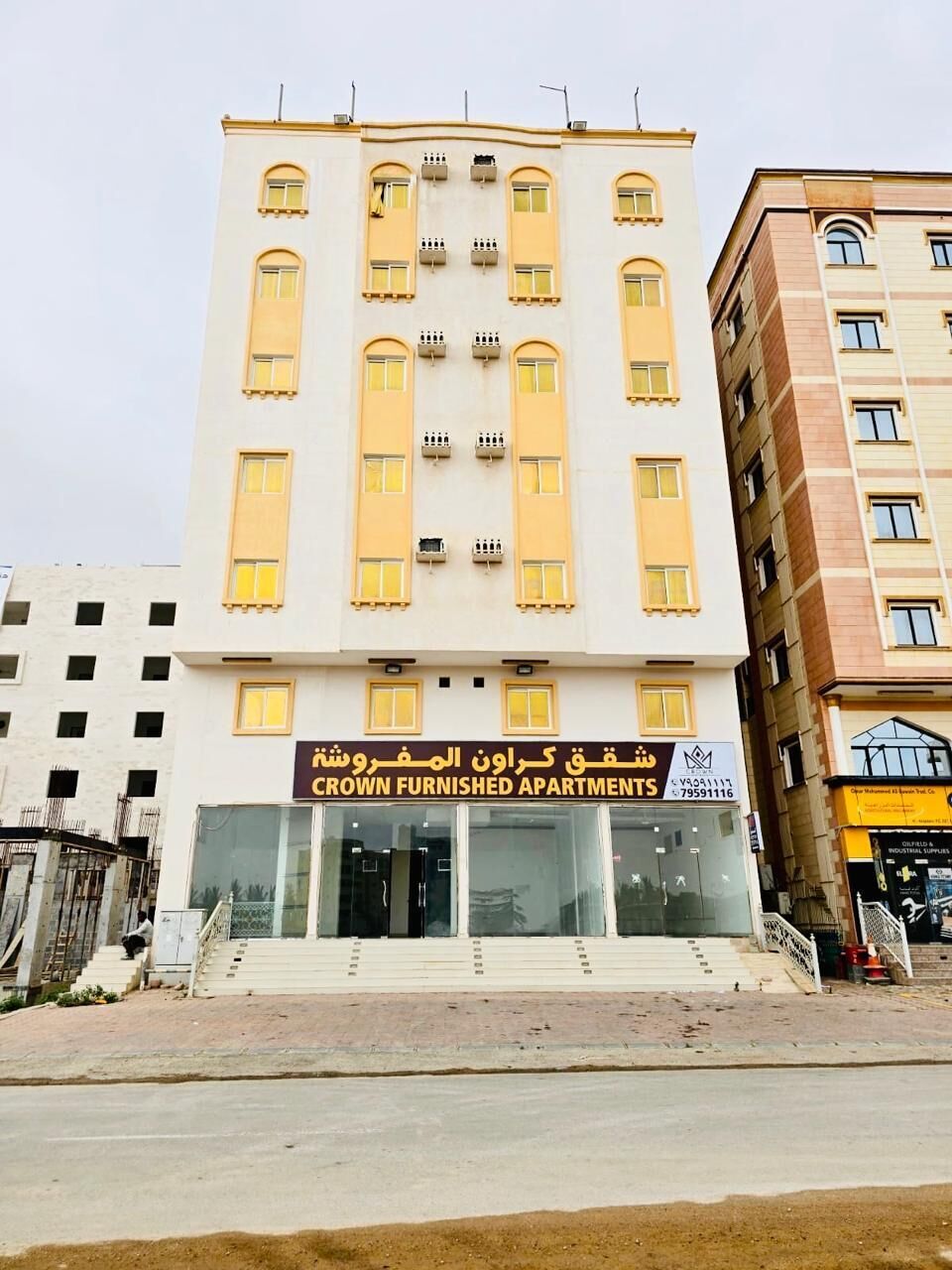 A multi-story building with a sign for 'Crown Furnished Apartments.' - CROWN FURNISHED APARTMENTS SALALAH (SALALAH)
