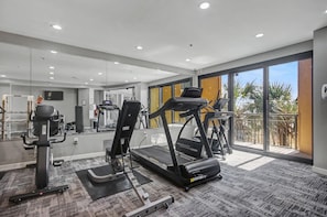 A gym with treadmills, exercise bikes, and a mirrored wall. - Ocean View 1BR Suite + Beach Access + Lazy River (Myrtle Beach)