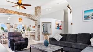 Ein modernes Wohnzimmer mit einer Couch, einem Sessel und einem Couchtisch.