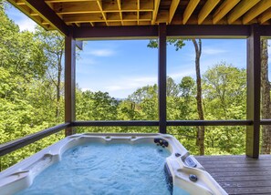 A hot tub under a wooden pergola with a forest view. - Gold Rain Retreat Newly Built! 4BD,3.5 BA in Smoky Mountain Retreat (Maggie Valley)