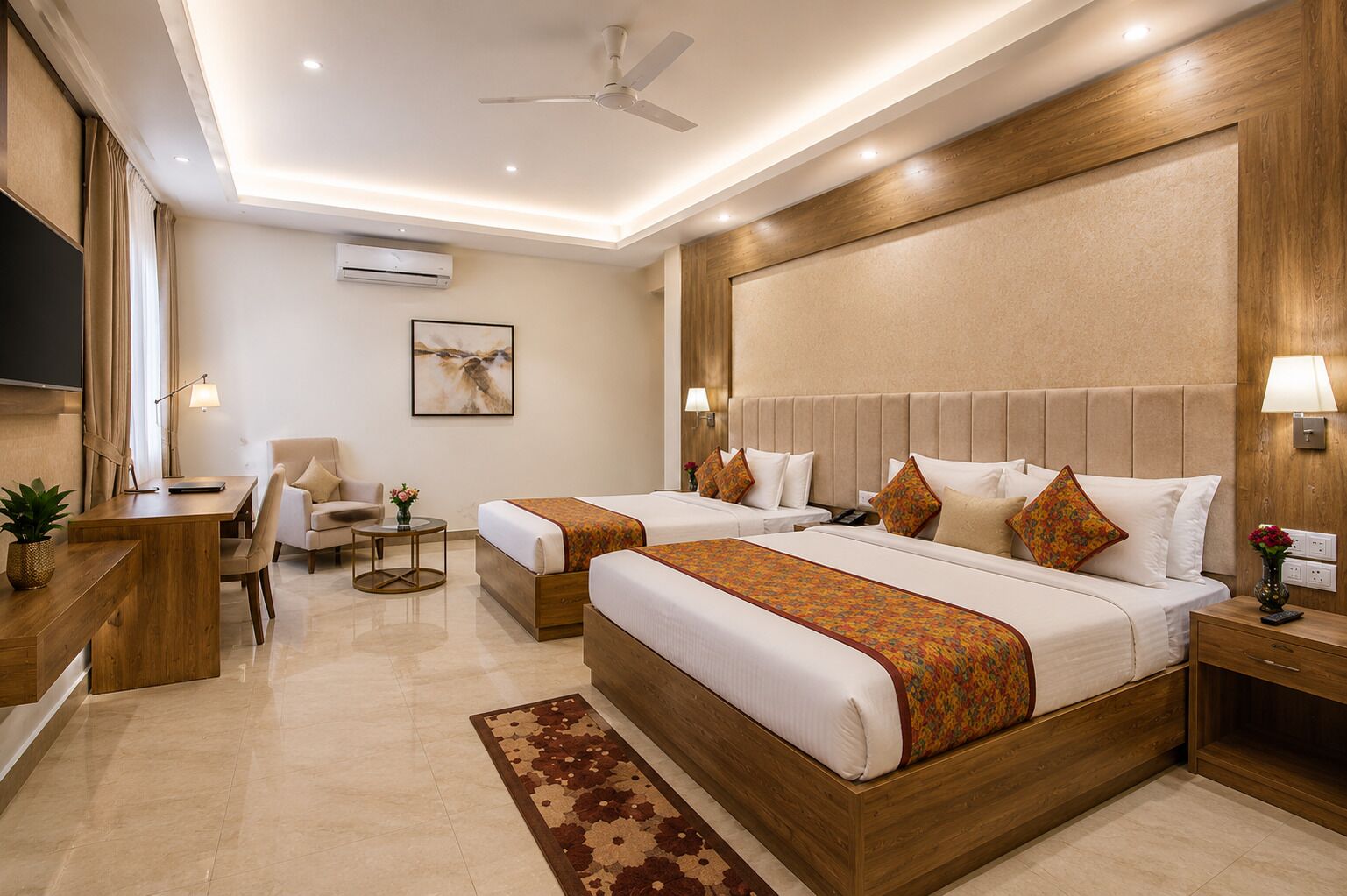 A hotel room with two beds, a desk, a chair, a TV, and a ceiling fan.