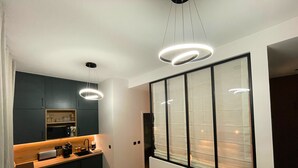 A modern interior with a kitchen, dining area, and seating space. - Comfortable & Peaceful Apartment, Latin Quarter - Newly Renovated (Paris)