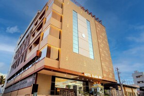 A multi-story hotel with a prominent entrance, balconies, and a clear sky. - Hotel Raaga Inn (Tirupati)