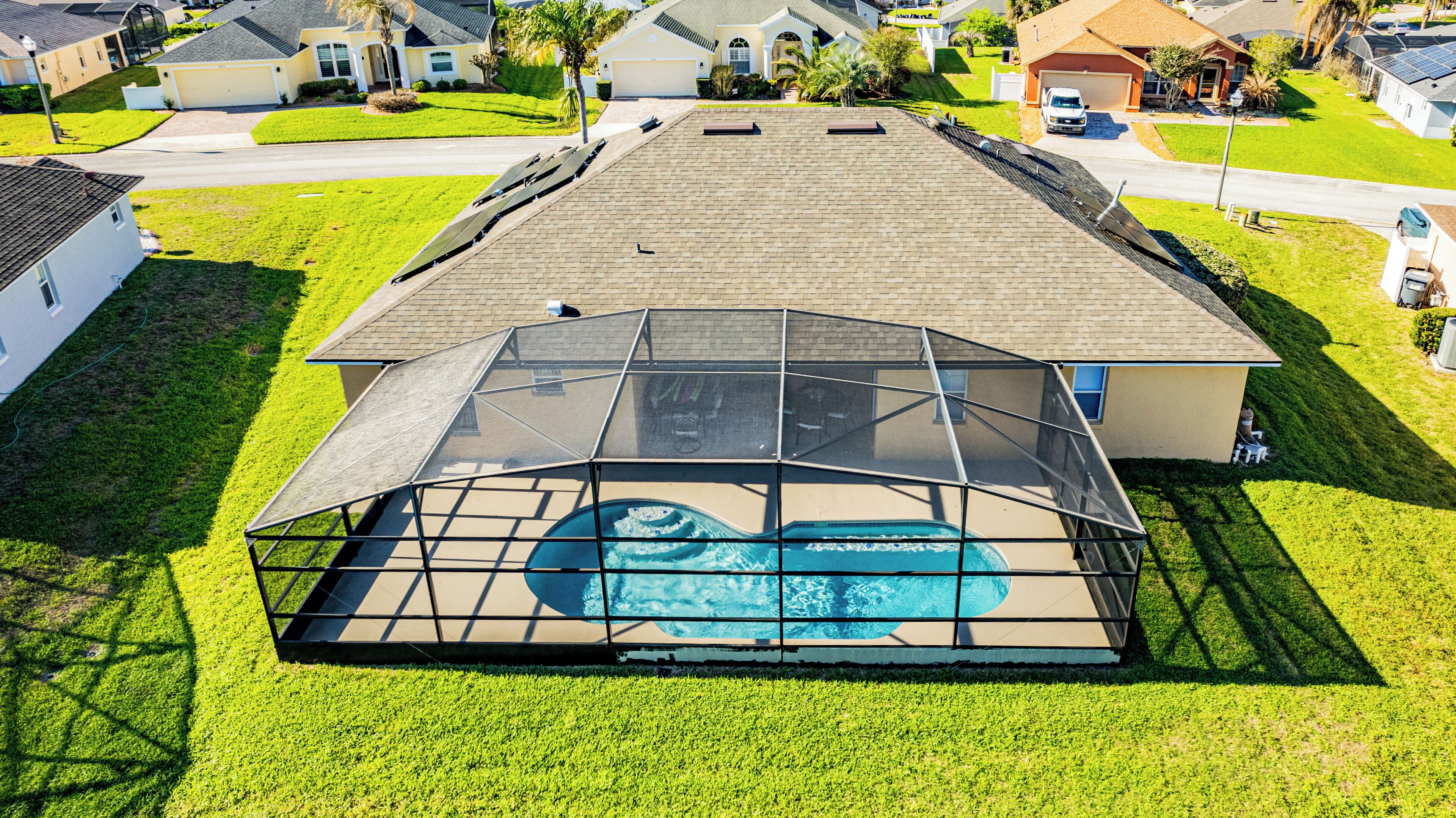 A residential area with houses, a swimming pool, and a covered patio.