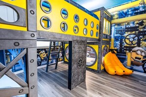 A play area with a Minion-themed design, including a slide and climbing structures. - 7BR Solara Resort Villa with Private Pool, Spa & Game Room (Kissimmee)