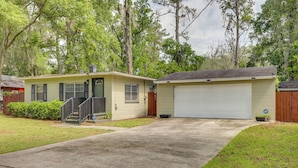 A single-story house with a garage, a front porch, and a small front yard.