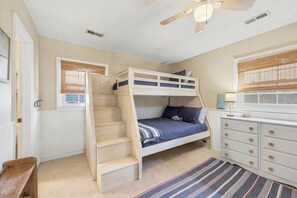 A bunk bed with a wooden ladder, a white dresser, and a window with blinds. - Springtide - 3-bedrooms - Newly Remodeled (Pawleys Island)