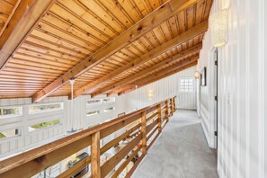 A covered wooden balcony with a view of the surrounding area. - Springtide - 3-bedrooms - Newly Remodeled (Pawleys Island)