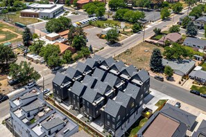 A modern building with a unique geometric roof design, surrounded by a residential neighborhood. - Walkable Location: Pet-friendly Denver Townhome (Denver)