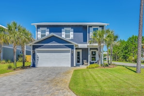 A two-story house with a garage, a well-maintained lawn, and palm trees. - Close to Beach! Miramar Beach Haven w/ Pool Access (Miramar Beach)