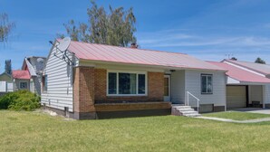A single-story house with a red roof, a brick section, and a satellite dish. - Hike, Golf & Fish! Pet-friendly Getaway in Ashton (Ashton)