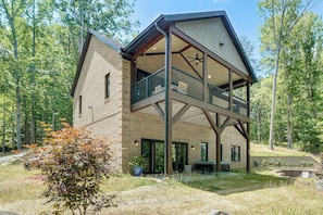 A two-story house with a balcony, large windows, and a brick exterior. - Roxboro Lake Family Retreat and Spa (Prospect Hill)