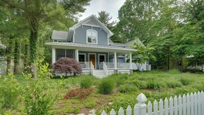 A two-story house with a porch, surrounded by lush greenery and a white picket fence. - South Haven Family Lake Getaway 4 Mi to Downtown (South Haven)