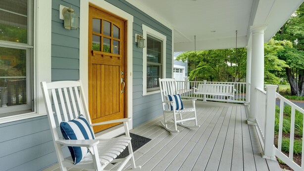 A porch with two rocking chairs, a wooden door, and a white railing. - South Haven Family Lake Getaway 4 Mi to Downtown (South Haven)