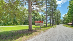 A gravel road leading to a sign for White Oak Cabins and RV. - Near Trails! Ozark Mtn Hideaway w/ Fire Pit, Grill (Fifty-Six)