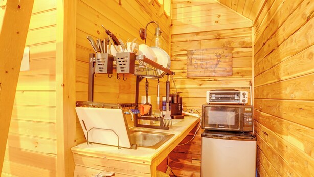 A compact kitchen with wooden walls, a sink, a microwave, and a coffee maker. - Near Trails! Ozark Mtn Hideaway w/ Fire Pit, Grill (Fifty-Six)