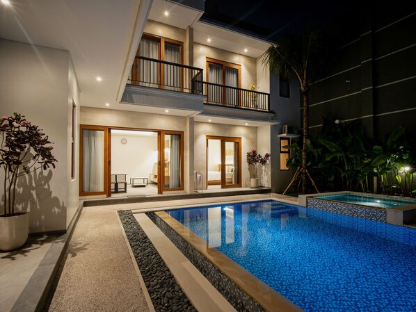 A two-story building with a swimming pool, large windows, and a balcony. - Villa RL Sanur (Sanur)