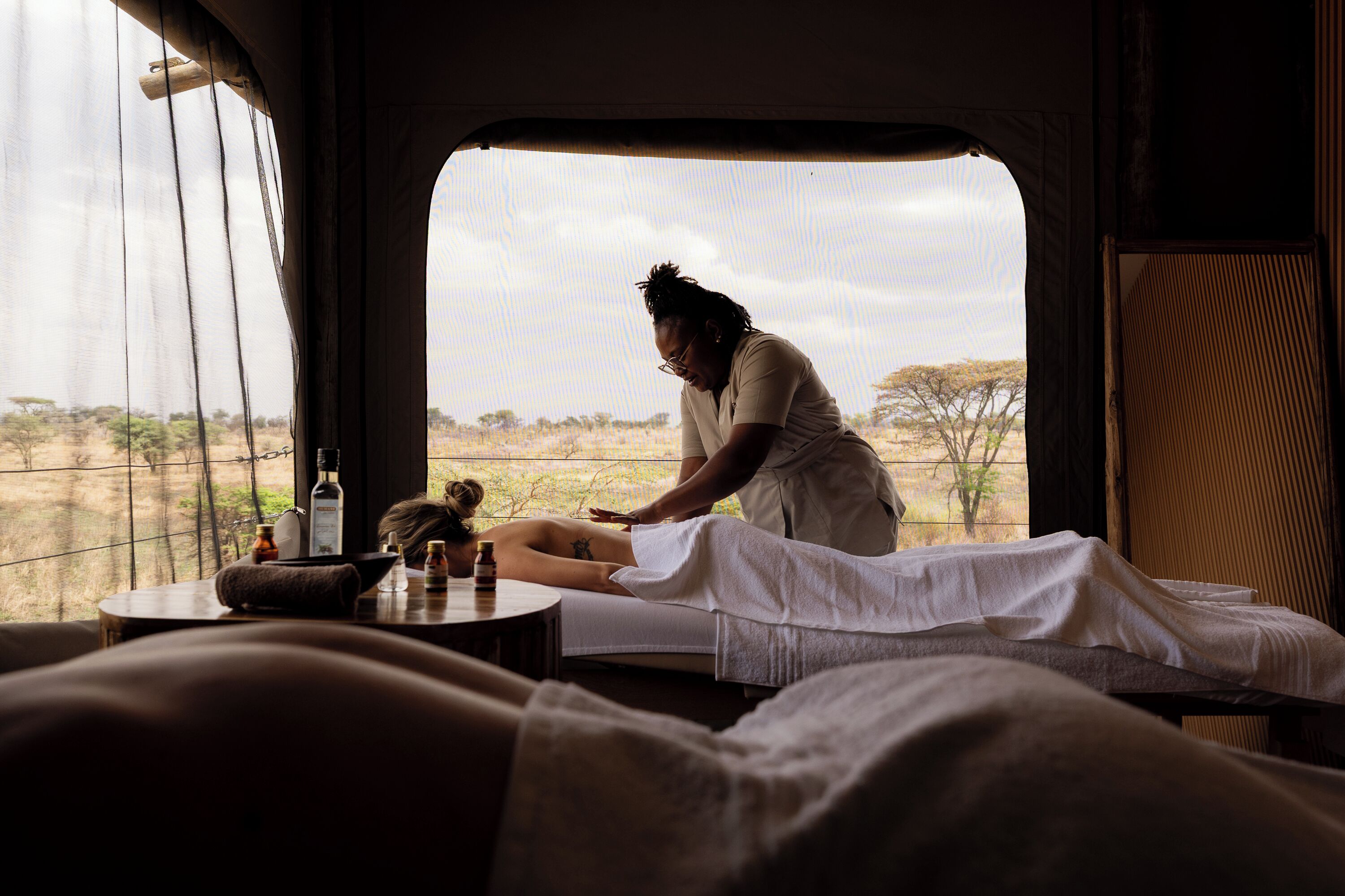 A room with a bed, a window, and a view of the outdoors.