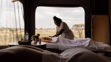 A room with a bed, a window, and a view of the outdoors.