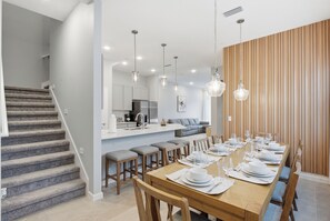A modern kitchen with white cabinets, a built-in oven, and a coffee machine. - Luxury 5BR Villa w/ 4 Private Suites | Heart of Orlando (Orlando)