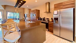A modern kitchen with a stainless steel refrigerator, a built-in oven, and a coffee maker. - Perfect Getaway | 3 En-Suites with Jacuzzi & BBQ (Kissimmee)