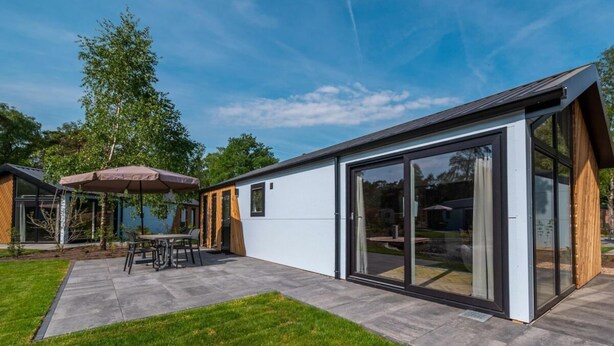 A modern house with a patio, a dining area, and a large sliding glass door. - Holiday Home in Arnhem With Terrace (Arnhem)