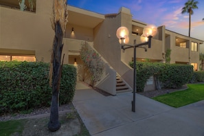 A modern building with a staircase, outdoor lighting, and a well-maintained garden. - Charming Downtown Palm Springs Getaway 1 Bedroom Condo (Palm Springs)