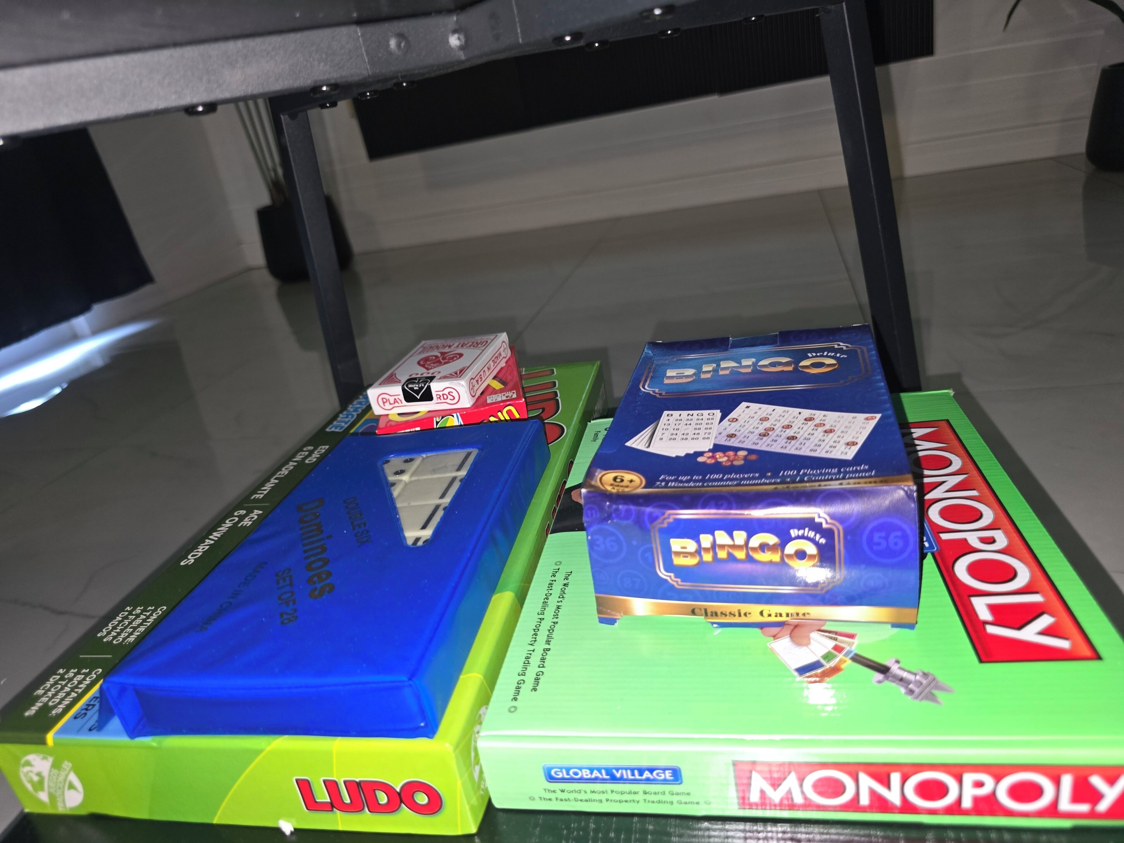 A table with board games Monopoly and Ludo.