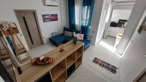 A modern apartment with a living area, a dining space, and a kitchen. - My Hersonissos Home - Luxury Suite (Hersonissos)