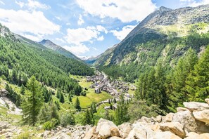 A mountainous landscape with a village nestled in a valley.