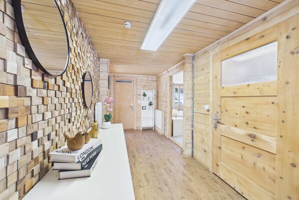 A wooden interior with a reception desk, books, and a mirror.