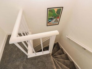 A staircase with a white handrail and a carpeted landing. - Saltaire House (Shipley)