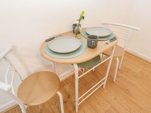 A dining table with plates, cutlery, and a vase with flowers. - Saltaire House (Shipley)