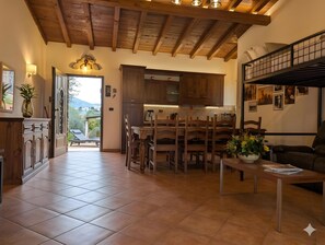 A spacious kitchen with wooden cabinets and a dining area with a table and chairs.