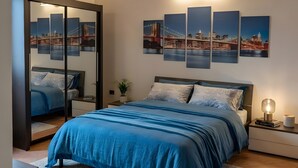 A bedroom with a bed, nightstands, a mirror, and wall art. - Velletri, elegant guesthouse with pool (Greta's Villa) (Velletri)