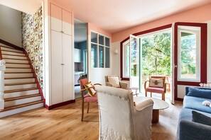 A staircase leading to a room with a view of greenery, a dining area with a table and chairs, and a sofa. - Saint-Palais-sur-Mer · House for 10 people · Beach and town center 250 m away (Saint-Palais-sur-Mer)