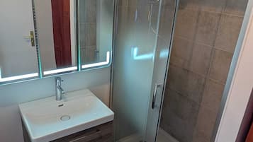 Shower, hair dryer, towels, toilet paper