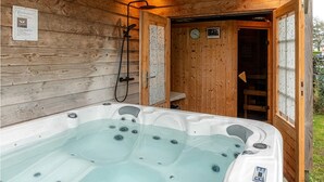 A wooden cabin with a hot tub, wooden walls, and a door leading to a shower area. - Chic Holiday Home in Friesland for 6 (Tzummarum)