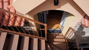 A staircase with metal railings leading to a wooden interior.