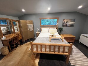 A bedroom with a bed, wooden furniture, a desk, a wardrobe, and a window with a view. - Valhalla Cottage, hunters or skiers dream! Slocan Valley’s sweet spot! (Central Kootenay H)